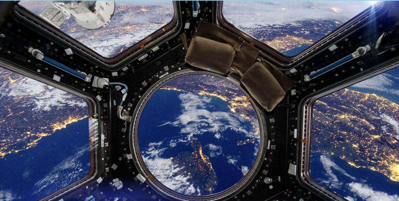 A view of planet earth and a satellite from a space shuttle window